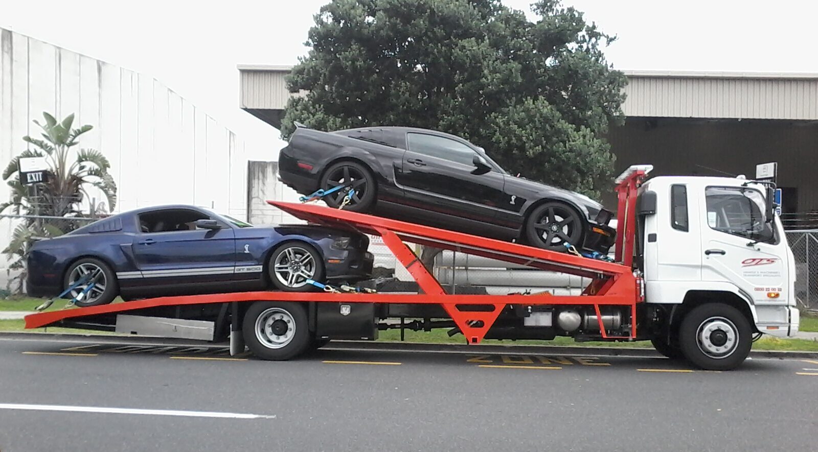 Tow Truck transporting two sport cars