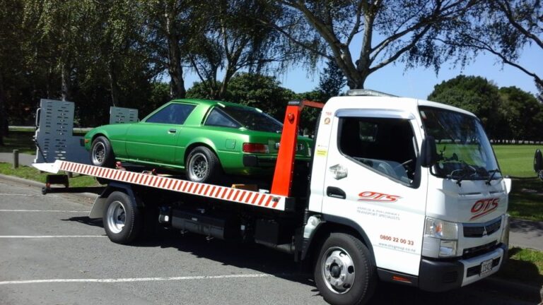 Tow truck transporting classic sports car
