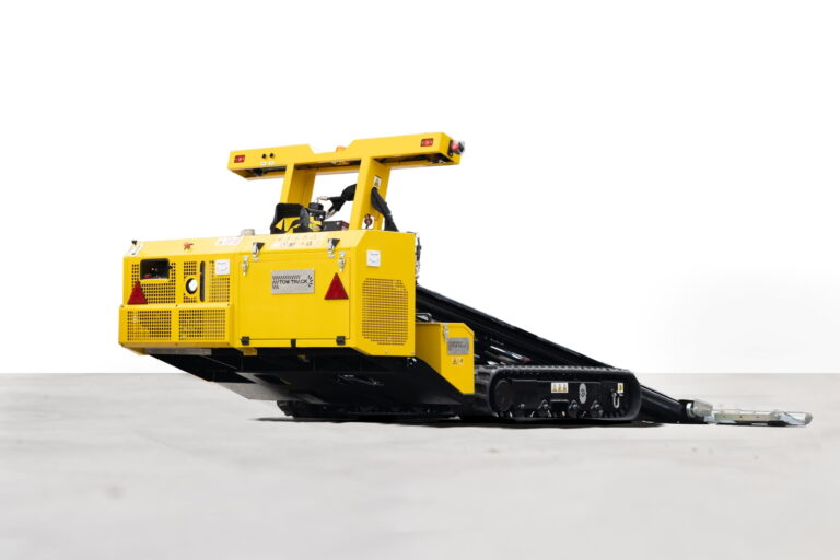 Track machine looks like robot, for towing cars in hard spots, rear angle