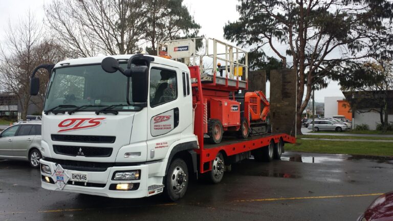 Onehunga towing truck transporting two machines