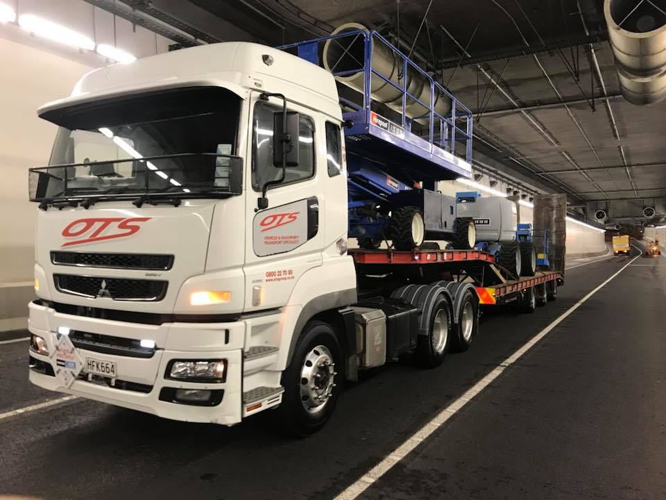 OTS - Onehunga Towing Services Truck driving with two machines in tunnel
